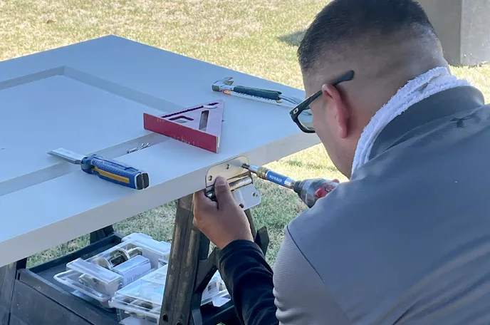 Derrick from DL Home Solutions installing door hardware